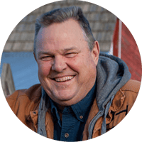 Jon Tester's broad smile is framed within a headshot