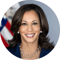 Kamala Harris headshot with the US flag in the background. She is smiling.